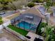 Aerial shot showing a fully screened pool and jacuzzi; an inviting oasis for outdoor relaxation at 290 Thomas Dr, Casselberry, FL 32707