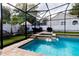 Tranquil screened in pool with spa and patio seating at 290 Thomas Dr, Casselberry, FL 32707