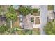 Birds-eye-view depicts house with mature landscaping, adjacent pool, fence, and neighborhood street at 2909 Depauw Ave, Orlando, FL 32804