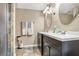 A newly renovated bathroom with black cabinets, double sinks and stone-walled shower provides modern comfort and style at 2909 Depauw Ave, Orlando, FL 32804