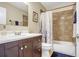 Bathroom with vanity, toilet, and shower/tub with decorative tile surround at 2909 Depauw Ave, Orlando, FL 32804