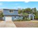 Exterior of a charming blue two-story home with attached garage and well-maintained lawn at 2909 Depauw Ave, Orlando, FL 32804