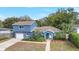 Charming two-story home featuring lush landscaping, a well-manicured lawn, and an attached garage at 2909 Depauw Ave, Orlando, FL 32804