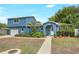 Charming blue two-story home with well-manicured lawn, lush landscaping and inviting walkway at 2909 Depauw Ave, Orlando, FL 32804