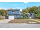 Exterior of a charming blue two-story home with attached garage, and well-maintained landscaping at 2909 Depauw Ave, Orlando, FL 32804