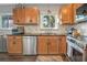 Well-lit kitchen with stainless steel appliances, granite countertops, and wooden cabinets at 2909 Depauw Ave, Orlando, FL 32804