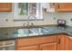 Close up of kitchen sink with stainless steel faucet and granite countertops at 2909 Depauw Ave, Orlando, FL 32804