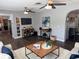 Inviting living room featuring hardwood floors, ceiling fans, and stylish decor with a view into the kitchen at 2909 Depauw Ave, Orlando, FL 32804