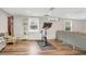 Spacious living room with hardwood floors, a comfortable seating area, natural light, and space for exercise equipment at 2909 Depauw Ave, Orlando, FL 32804