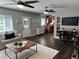 Open living area with dark floors, a cozy rug, and a view to the kitchen at 2909 Depauw Ave, Orlando, FL 32804