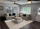 Comfortable living room with a plush rug, neutral furniture, and natural lighting at 2909 Depauw Ave, Orlando, FL 32804