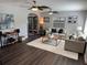 Bright living room features wood floors, ceiling fans, and a neutral color scheme at 2909 Depauw Ave, Orlando, FL 32804