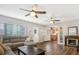 Living room featuring hardwood floors, sectional sofa, and a fireplace with an adjacent kitchen at 2909 Depauw Ave, Orlando, FL 32804