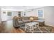 Bright living room boasts a plush sectional sofa, modern coffee table, and hardwood floors, creating an inviting space at 2909 Depauw Ave, Orlando, FL 32804