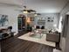 Inviting living room with dark floors, ceiling fans, and an open doorway to the backyard at 2909 Depauw Ave, Orlando, FL 32804