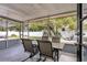 Inviting screened porch with table, chairs and view of backyard fire pit at 2909 Depauw Ave, Orlando, FL 32804