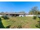 Large backyard featuring a swing set, outdoor grill, and a fully fenced-in yard at 3117 Lake Mar Ln, Orlando, FL 32806
