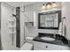 Updated bathroom featuring modern fixtures, a sleek vanity, and a tiled walk-in shower at 3117 Lake Mar Ln, Orlando, FL 32806