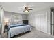 Cozy bedroom boasts a ceiling fan, closet, and bright window creating a relaxing atmosphere at 3117 Lake Mar Ln, Orlando, FL 32806