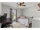Comfortable bedroom with a modern ceiling fan and bright window, creating a relaxing atmosphere at 3117 Lake Mar Ln, Orlando, FL 32806