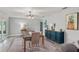 Spacious dining room featuring modern table, area rug, and view to adjacent living area and sliding glass doors at 3117 Lake Mar Ln, Orlando, FL 32806