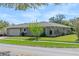 A well-maintained single-story home featuring stone details and an attached two-car garage at 3117 Lake Mar Ln, Orlando, FL 32806