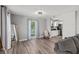Open-concept living area with hardwood floors, view into the kitchen and lots of light at 3117 Lake Mar Ln, Orlando, FL 32806