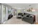 Bright living room with a gray sectional sofa, and multiple windows providing natural light at 3117 Lake Mar Ln, Orlando, FL 32806