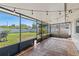 Screened patio with tile floor, backyard view, and string lights at 3117 Lake Mar Ln, Orlando, FL 32806