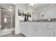 Well-lit bathroom with granite counters, white cabinets, and a sleek glass shower at 3962 Lana Ave, Davenport, FL 33897
