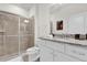 Bright bathroom featuring a granite countertop, white cabinets, and a glass door shower at 3962 Lana Ave, Davenport, FL 33897