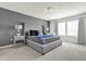 Beautiful bedroom featuring a large bed, stylish lamps, and modern grey accent wall at 3962 Lana Ave, Davenport, FL 33897