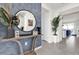 Welcoming entryway with modern decor, decorative mirror, and stylish blue accent wall at 3962 Lana Ave, Davenport, FL 33897