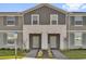 Charming townhome featuring neutral paint, complemented by a well-manicured lawn at 3962 Lana Ave, Davenport, FL 33897