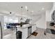 Kitchen with stainless steel appliances, granite countertops, white cabinetry, and seamless flow to other rooms at 3962 Lana Ave, Davenport, FL 33897