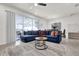 Open-concept living area featuring a large blue couch, a stylish rug, and access to the outdoor patio at 3962 Lana Ave, Davenport, FL 33897