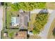 Aerial view of home featuring a pool, backyard, driveway, and lush greenery at 4210 Shorecrest Dr, Orlando, FL 32804