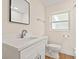 Updated bathroom with a bright, modern vanity, framed mirror, and tile-look flooring at 4210 Shorecrest Dr, Orlando, FL 32804