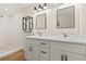 Bright bathroom with a double vanity, modern lighting, and sleek fixtures in white at 4210 Shorecrest Dr, Orlando, FL 32804