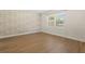 Neutral bedroom features wood-look tile floors and large window for lots of natural light at 4210 Shorecrest Dr, Orlando, FL 32804