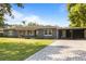Inviting home with a brick-paved driveway leading to a covered carport at 4210 Shorecrest Dr, Orlando, FL 32804