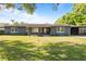 Charming single-story home featuring a well-manicured lawn and a covered carport at 4210 Shorecrest Dr, Orlando, FL 32804