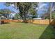 Large backyard featuring a newly installed wooden privacy fence, surrounded by trees at 4215 Kildaire Ave, Orlando, FL 32812