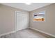 Bright bedroom featuring new floors, a closet, fresh paint, and a window overlooking the backyard at 4215 Kildaire Ave, Orlando, FL 32812