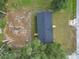 Overhead view of a home's roof and yard surrounded by trees and greenery at 5045 Se 148Th St, Summerfield, FL 34491