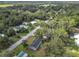 Expansive aerial shot of a neighborhood dotted with homes amidst lush greenery and trees at 5045 Se 148Th St, Summerfield, FL 34491