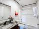 Well-lit bathroom showcasing a marble-look countertop, white cabinets, and a shower-tub combo at 5045 Se 148Th St, Summerfield, FL 34491