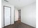 Neutral bedroom featuring plush carpeting, white walls, and multiple doors for easy access at 5045 Se 148Th St, Summerfield, FL 34491