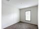 Bright carpeted bedroom featuring a window with blinds at 5045 Se 148Th St, Summerfield, FL 34491