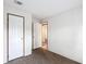 Cozy carpeted bedroom with three white paneled doors at 5045 Se 148Th St, Summerfield, FL 34491